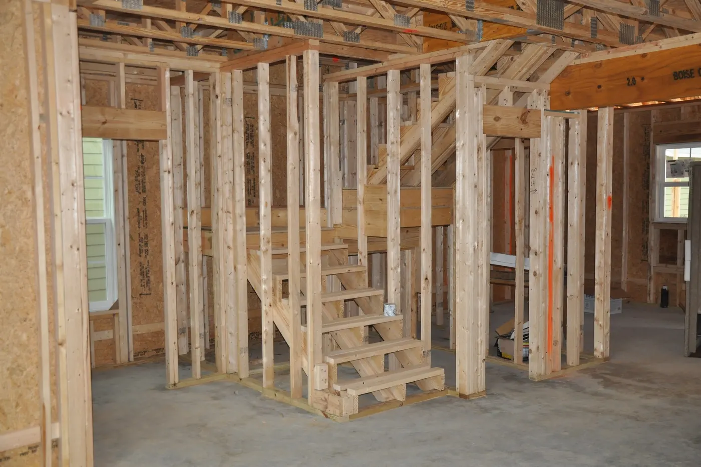 A basement framed out with new studs and a staircase