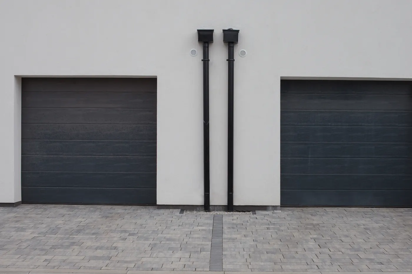 Two charcoal sectional garage doors on a modern home