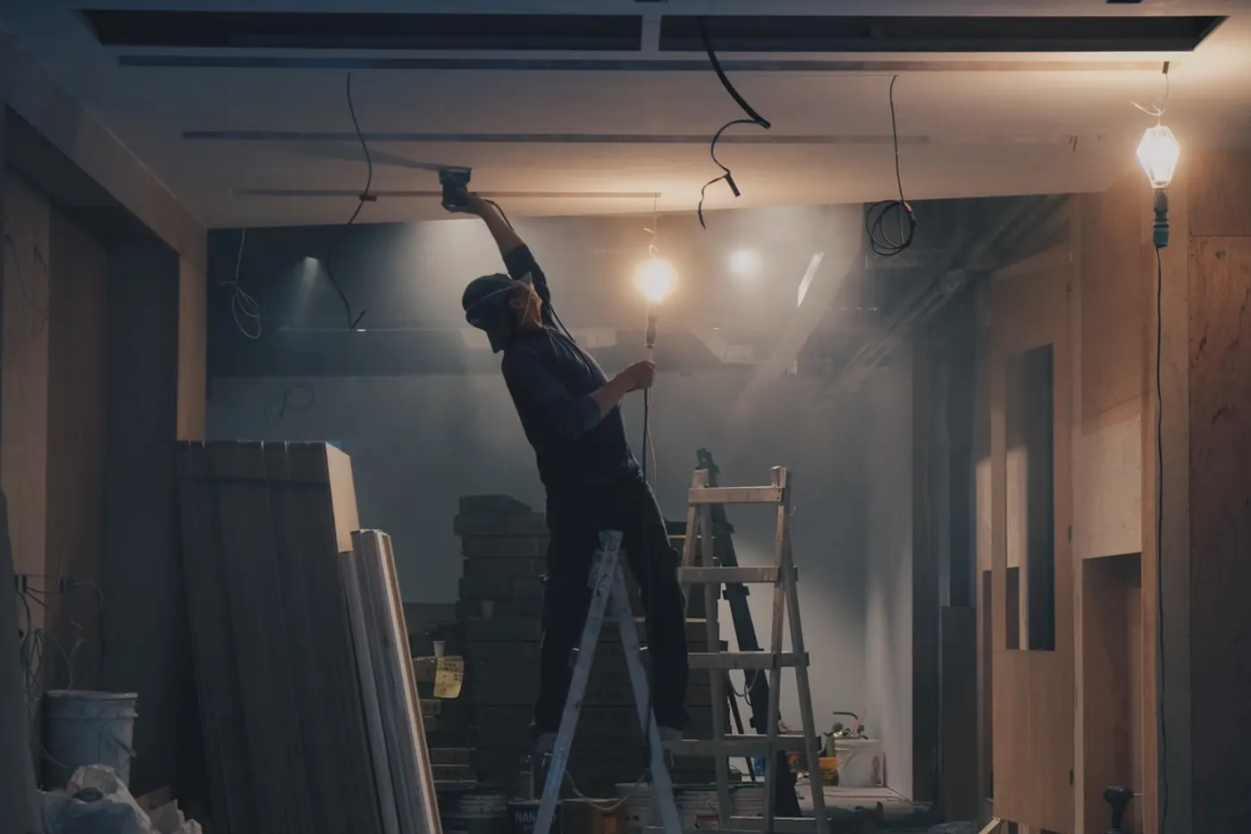A contractor working on a ceiling during an interior remodel