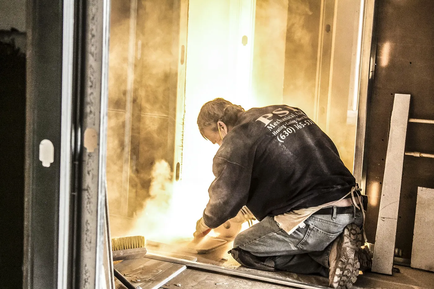 A tradesman fitting out a room partway through a remodel