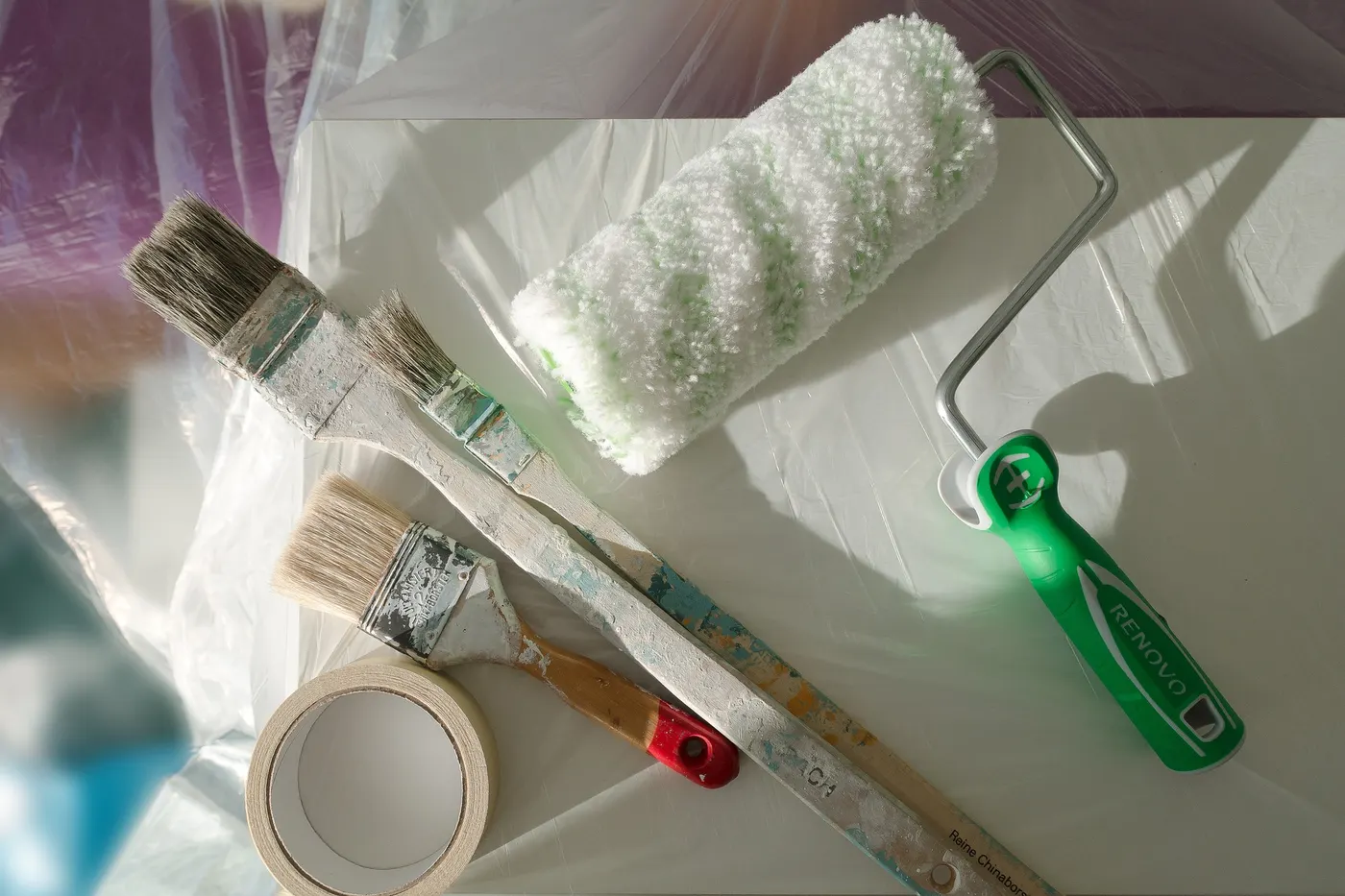 Paint rollers, brushes and tape ready for interior painting