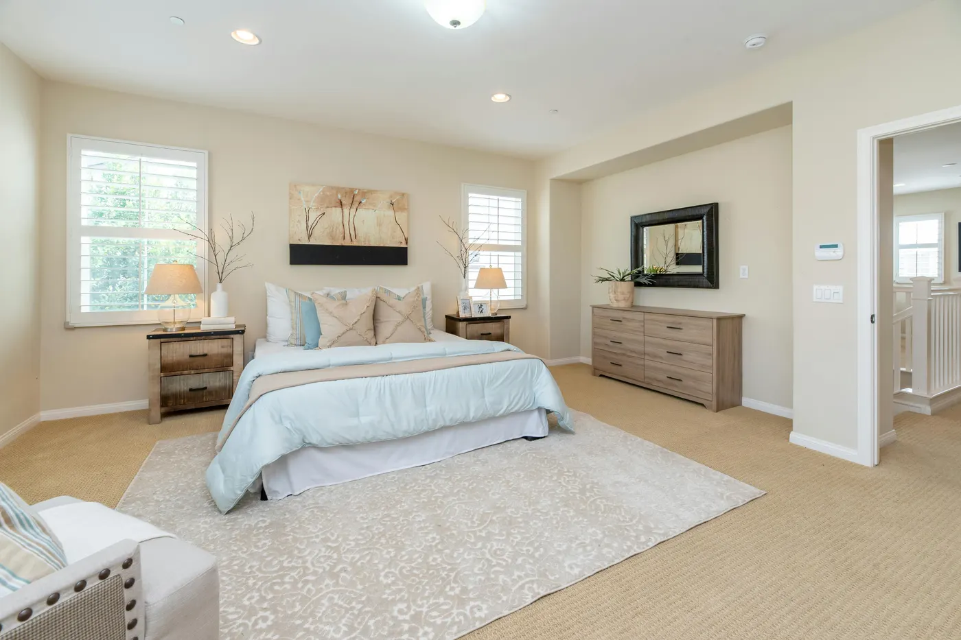 A bedroom with fresh neutral walls, new carpet and trim
