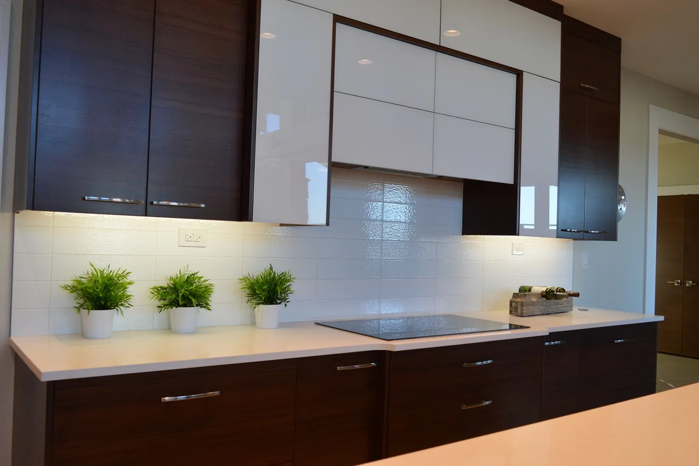 A kitchen with a white subway tile backsplash